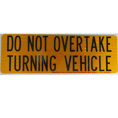 do not overtake turning vehicle sign